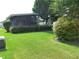Nicely landscaped property with lush green lawn and mature shrubs at 432 Santa Fe E Rd, Tavares, FL 32778