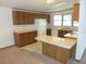 Traditional kitchen featuring wood cabinets, white appliances, and neutral countertops at 432 Santa Fe E Rd, Tavares, FL 32778