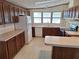 Traditional kitchen with oak cabinets, laminate counters and bright natural light at 432 Santa Fe E Rd, Tavares, FL 32778