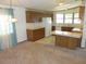 Traditional kitchen with wooden cabinets, white appliances, and a breakfast bar at 432 Santa Fe E Rd, Tavares, FL 32778