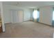 Bright living room with neutral carpet, large windows and sliding glass door at 432 Santa Fe E Rd, Tavares, FL 32778