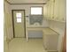 Utility/Mud room with exterior door, window, built-in countertop and cabinets at 432 Santa Fe E Rd, Tavares, FL 32778
