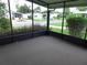 Relaxing screened-in porch with views of the landscaped front yard and neighborhood at 432 Santa Fe E Rd, Tavares, FL 32778