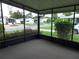 Enjoy neighborhood views from this screened-in porch with neutral carpeting at 432 Santa Fe E Rd, Tavares, FL 32778