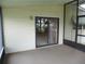 Covered porch with sliding glass doors providing access to the home's interior at 432 Santa Fe E Rd, Tavares, FL 32778