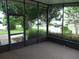 Screened-in porch offers a relaxing space with neighborhood views and a screened door at 432 Santa Fe E Rd, Tavares, FL 32778