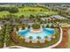 Aerial view of the community pool, tennis courts, lake and golf course at 4701 Nw 51St Terrace Rd, Ocala, FL 34482