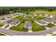 An aerial view shows the neighborhood, its winding street, and well manicured lawns at 4701 Nw 51St Terrace Rd, Ocala, FL 34482