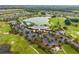 Aerial view showcasing the community clubhouse, pool, lake, and golf course at 4701 Nw 51St Terrace Rd, Ocala, FL 34482