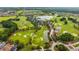 Aerial view of a lush golf course community with ponds, mature trees and manicured greens at 4701 Nw 51St Terrace Rd, Ocala, FL 34482