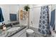 Bright bathroom featuring a granite vanity, patterned shower curtain, and natural light at 4701 Nw 51St Terrace Rd, Ocala, FL 34482