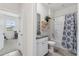 Bright bathroom featuring a granite vanity, patterned shower curtain, and natural light at 4701 Nw 51St Terrace Rd, Ocala, FL 34482