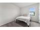 Neutral bedroom with plush carpet and a simple twin bed near natural light at 4701 Nw 51St Terrace Rd, Ocala, FL 34482