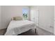 Bright bedroom features a comfortable bed, window overlooking the yard and double door closet at 4701 Nw 51St Terrace Rd, Ocala, FL 34482