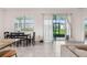 Sunlit dining area featuring tile floors, a table with four chairs and sliding glass door to the lanai at 4701 Nw 51St Terrace Rd, Ocala, FL 34482
