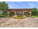 A decorative brick entrance with a portico, colorful flowers, and lush greenery offers curb appeal at 4701 Nw 51St Terrace Rd, Ocala, FL 34482