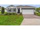 Charming one-story home with a brick driveway, manicured lawn, and professionally designed landscaping at 4701 Nw 51St Terrace Rd, Ocala, FL 34482