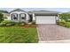 Charming one-story home with a brick driveway, manicured lawn, and professionally designed landscaping at 4701 Nw 51St Terrace Rd, Ocala, FL 34482