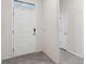 Inviting front door with transom window and modern digital lock hardware at 4701 Nw 51St Terrace Rd, Ocala, FL 34482