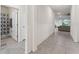 An open hallway with tile flooring leads to the living area and an adjacent bathroom at 4701 Nw 51St Terrace Rd, Ocala, FL 34482