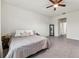 Large bedroom featuring neutral colors, tile floors, a ceiling fan, and ample natural light at 4701 Nw 51St Terrace Rd, Ocala, FL 34482