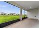 The covered lanai overlooks the backyard with lush green grass and views of neighboring homes at 4701 Nw 51St Terrace Rd, Ocala, FL 34482