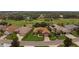 Aerial view of a home and its landscaped yard, surrounded by trees and green space at 4826 Sable Ridge Ct, Leesburg, FL 34748