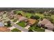 Expansive aerial view showcasing the charming neighborhood and surrounding green spaces of this beautiful home at 4826 Sable Ridge Ct, Leesburg, FL 34748