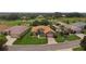 Aerial view showcasing a lovely landscaped home and well-manicured lawn in a green area at 4826 Sable Ridge Ct, Leesburg, FL 34748