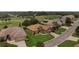 Stunning aerial view of a well-maintained home with lush landscaping and a perfectly manicured lawn at 4826 Sable Ridge Ct, Leesburg, FL 34748