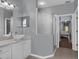 Well-lit bathroom with frameless shower, granite countertop vanity, and vessel sink at 4826 Sable Ridge Ct, Leesburg, FL 34748