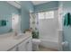 Bright bathroom featuring a shower-tub combo, tiled walls, and a white vanity sink at 4826 Sable Ridge Ct, Leesburg, FL 34748