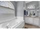 Relaxing bathroom features a soaking tub with jets and granite countertop vanity at 4826 Sable Ridge Ct, Leesburg, FL 34748