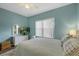 Comfortable bedroom with a ceiling fan, soft carpet and blue accent wall at 4826 Sable Ridge Ct, Leesburg, FL 34748