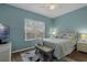 Inviting bedroom features a TV, window, and comfy furnishings at 4826 Sable Ridge Ct, Leesburg, FL 34748