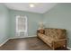 Inviting bedroom featuring a ceiling fan, wood-look floors, and a cozy futon at 4826 Sable Ridge Ct, Leesburg, FL 34748