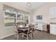 Dining area with seating for six, bright natural light, and tiled floor at 4826 Sable Ridge Ct, Leesburg, FL 34748