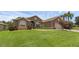 Inviting exterior with lush lawn, palm trees, and well-maintained landscaping at 4826 Sable Ridge Ct, Leesburg, FL 34748
