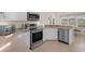 Bright kitchen features stainless steel appliances, ample counter space, and tiled floor at 4826 Sable Ridge Ct, Leesburg, FL 34748