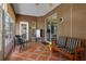 Enclosed lanai with tile floors and various seating arrangements at 4826 Sable Ridge Ct, Leesburg, FL 34748