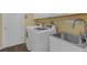 Clean laundry room featuring a washer, dryer, white cabinets, and a sink at 4826 Sable Ridge Ct, Leesburg, FL 34748