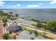 Aerial view showcasing a building near a lake, complemented by a small airport, trains, and surrounding greenery at 504 Banning Beach Rd, Tavares, FL 32778