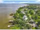 Aerial view of waterfront homes with lush trees and docks, nestled by the serene lake, showcasing natural beauty at 504 Banning Beach Rd, Tavares, FL 32778