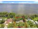 Aerial view showing the property's proximity to the water and surrounding greenery at 504 Banning Beach Rd, Tavares, FL 32778
