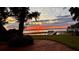 Beautiful backyard brick patio with a lake view at sunset at 504 Banning Beach Rd, Tavares, FL 32778