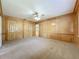 Large bedroom with paneled walls, carpet and large double closets at 504 Banning Beach Rd, Tavares, FL 32778