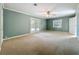 Empty bedroom with neutral carpet, French doors to backyard, and ceiling fan at 504 Banning Beach Rd, Tavares, FL 32778