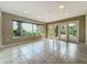 Bright and open bonus room with tile flooring and a picturesque lake view at 504 Banning Beach Rd, Tavares, FL 32778
