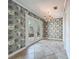Dining room with decorative wallpaper, red chandelier, and access to the backyard at 504 Banning Beach Rd, Tavares, FL 32778