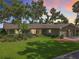 Beautiful one-story home with mature trees, green lawn, and charming curb appeal at 504 Banning Beach Rd, Tavares, FL 32778